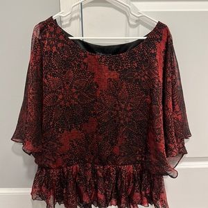 Gorgeous red with black floral accent blouse. Black built in cami. Flowy sleeve